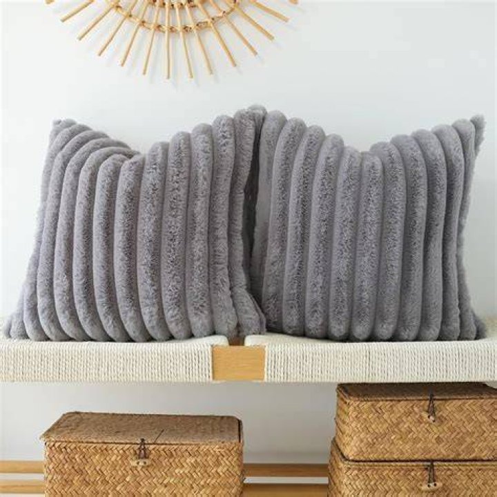 Four different-colored JOJUSIS Fluffy Decorative Throw Pillows with Covers on sofa