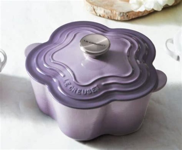 Purple and pink Le Creuset Flower Plates on table